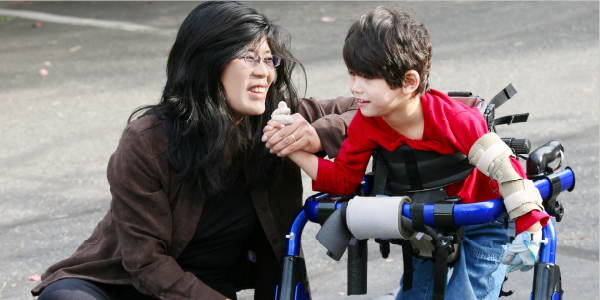 Teacher with a student with specialized walker